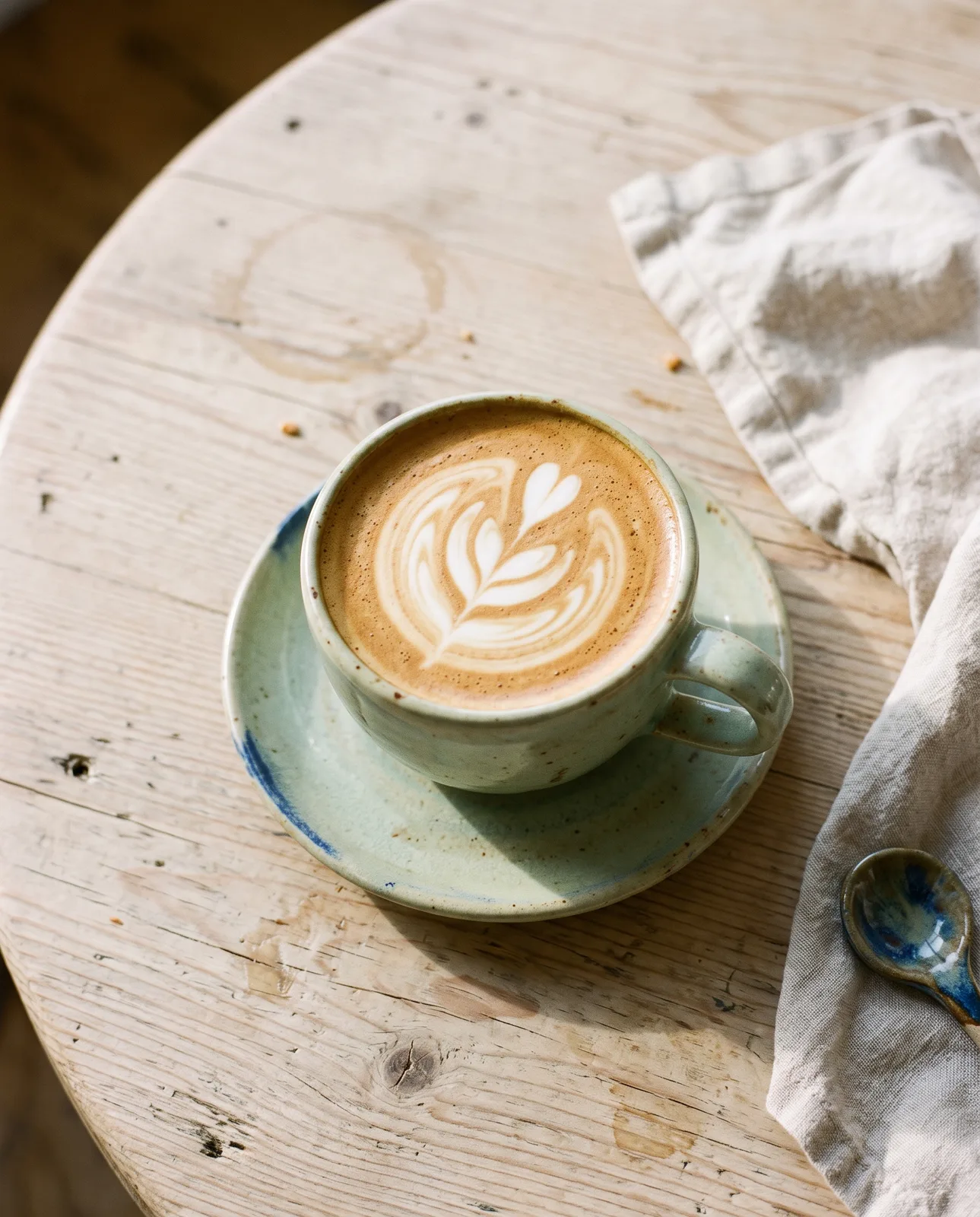 Latte art in a celadon cup
